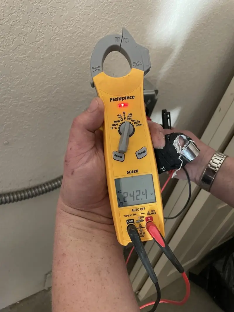 Voltage testing with clamp meter during Recessed Lighting Installation in Mila Doce